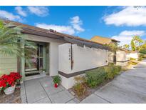 Inviting condo exterior featuring a well-manicured walkway and landscaping at 2394 Sun Valley Cir # 2394, Winter Park, FL 32792