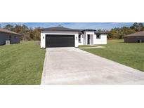 New construction home with a modern facade and attached garage at 2571 Sw 153Rd Lane, Ocala, FL 34473