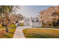 Modern two-story home with a detached garage and paved driveway at 3000 Tohopekaliga Dr, St Cloud, FL 34772