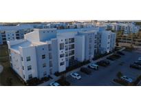 Apartment building with modern design, multiple floors, and ample parking at 3180 Paradox Cir # 102, Kissimmee, FL 34746