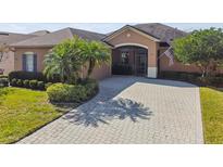 Attractive single-story home with paver driveway and landscaping at 412 Sorrento Rd, Kissimmee, FL 34759