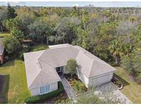 Single-story house with a two-car garage and manicured lawn at 554 Heartwell Dr, Kissimmee, FL 34759