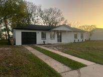 Charming single-story home with a well-maintained front yard and an inviting covered porch at 188 Citrus Dr, Kissimmee, FL 34743