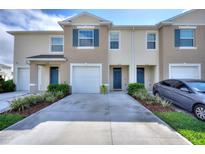 Inviting townhouse exterior with well-manicured landscaping and private driveway at 2352 Tay Wes Dr, St Cloud, FL 34771