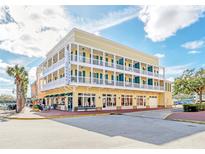 Three-story building with balconies and ground floor retail at 600 Market St # 210, Celebration, FL 34747