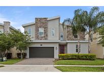 Two-story modern home with stone accents and landscaped yard at 641 Pebble Beach Dr, Davenport, FL 33896