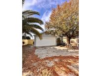 Newly renovated home with a spacious front yard and driveway at 656 Oakford Way, Orlando, FL 32811