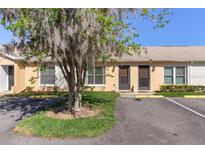 Charming exterior view of a well-maintained single-story home with assigned parking and beautiful landscaping at 33 W Country Cove Way, Kissimmee, FL 34743
