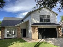 Charming two-story home featuring a two-car garage, brick accents, and well-maintained landscaping at 1063 Eagles Forrest, Apopka, FL 32712