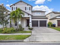 Charming two-story home with manicured landscaping, and a two car garage at 12814 Westside Village Loop, Windermere, FL 34786