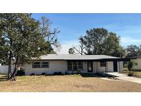 Newly renovated ranch home featuring a modern exterior and landscaped yard at 2111 Hollywood Dr, Leesburg, FL 34748