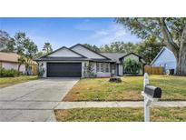 Charming single-story home featuring a well-maintained lawn, two-car garage, and neutral paint scheme at 2417 Liela Lee Ct, Ocoee, FL 34761