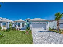 Charming single-Gathering home boasting a manicured lawn and brick paved driveway at 306 Hang Loose Way, Daytona Beach, FL 32124