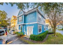 Charming blue two-story townhome with white trim and a well-maintained lawn in a quiet community at 4000 San Gallo Dr # 102, Kissimmee, FL 34741