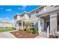 Modern 2 story home with gray exterior, walkway, and landscaping at 4976 Windermere Ave, Kissimmee, FL 34746
