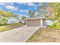 House exterior featuring a taupe garage door and well-manicured lawn at 125 Young Pl, Lakeland, FL 33803