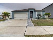 Curb appeal abounds at this charming one-story home, featuring a landscaped yard and two-car garage at 1836 Delrose Rd, Kissimmee, FL 34744