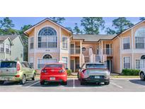 Two-story condo building with parking and landscaping at 2035 Royal Bay Blvd # 45, Kissimmee, FL 34746