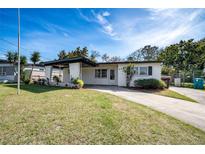 Charming single-story home with a well-manicured lawn and inviting covered entryway at 5438 San Luis Dr, Orlando, FL 32807