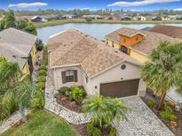 Attractive single-story home with lake view and paver driveway at 669 Grand Canal Dr, Kissimmee, FL 34759