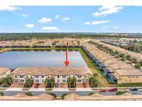 Aerial view of townhouses with lake access at 8886 Geneve Ct, Kissimmee, FL 34747