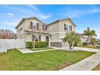 Charming two-story home with a well-maintained lawn and beautiful landscaping at 2849 Shelburne Way, St Cloud, FL 34772
