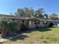 Ranch-style home with mature landscaping and a spacious yard at 780 Avenue H Ne, Winter Haven, FL 33881