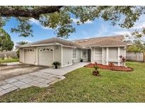 Charming single-story home with attached garages, complemented by a well-maintained lawn and tasteful landscaping at 7933 Merrimac Cove Dr, Orlando, FL 32822