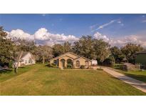 Inviting single-story home with well-maintained lawn, lovely landscaping, and a neutral color scheme at 1145 Sugar Belt Dr, St Cloud, FL 34771