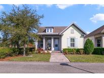 Charming single-story home with a well-manicured lawn and a welcoming front porch under a partly cloudy sky at 13432 Beebe Aly, Orlando, FL 32827