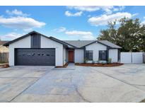 Beautiful one-story home with a two car garage and a well manicured front yard at 1410 Rena Ln, Kissimmee, FL 34744