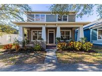 Charming two-story home featuring a covered front porch and well-maintained landscaping at 14637 Tanja King Blvd, Orlando, FL 32828