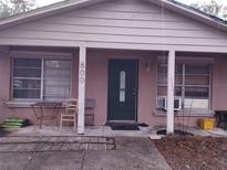 Modest home exterior with a covered front porch and some outdoor seating at 800 Nicole Blvd, Ocoee, FL 34761