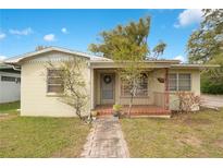 Charming single-story home featuring a brick walkway and cozy front porch at 900 Delaware Ave, St Cloud, FL 34769