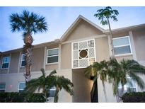 Inviting two-story condo with lush tropical landscaping and architectural detailing at 9916 Sweepstakes Ln # 7, Orlando, FL 32837