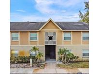 Charming two-story exterior showcasing brick accents, manicured landscaping, and inviting entryway at 2424 Barley Club Ct # 8, Orlando, FL 32837