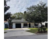Charming single-story home with a well-maintained front yard and attached garage at 332 Carolina Ave, St Cloud, FL 34769