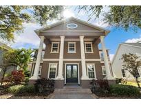 Stunning two-story home features grand columns and a beautifully landscaped front yard at 3329 Schoolhouse Rd, Harmony, FL 34773