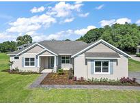 Charming single-story home with a manicured front yard, tidy landscaping, and neutral exterior paint at 5701 Crestview Dr, Lady Lake, FL 32159