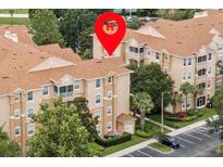Beautifully landscaped condo complex with mature trees and well-maintained grounds at 7671 Comrow St # 303, Kissimmee, FL 34747