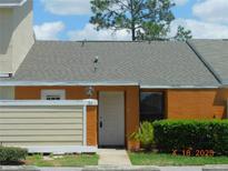 Inviting townhome featuring a well-kept lawn and a cozy front entrance, perfect for a starter home at 84 Silver Park Cir, Kissimmee, FL 34743