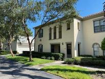 Well-maintained two-story condo with lush landscaping and a welcoming facade in a quiet community at 1001 Via Santae Ln # 201, Celebration, FL 34747