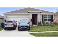 Charming single-story home with attached garage and well-manicured lawn in a suburban neighborhood at 1727 Buckeye Rd, Davenport, FL 33837