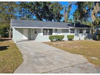 Charming single-story home with a well-maintained lawn and a concrete driveway at 2209 Sw 6Th St, Ocala, FL 34471