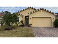 Well-maintained single-story home featuring a two-car garage and mature landscaping at 2523 Salzburg Loop, Winter Haven, FL 33884