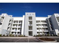 Modern four-story apartment building with balconies and well-maintained landscaping on a sunny day at 3120 Paradox Cir # 204, Kissimmee, FL 34746