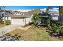 Charming single-Gathering home with a two-car garage, lush landscaping, and a well-maintained lawn at 331 Henley Cir, Davenport, FL 33896