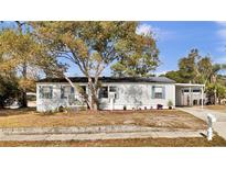 Charming single-story home with a well-kept front yard and covered parking space at 415 N Winter Park Dr, Casselberry, FL 32707