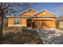 Charming single-story home with an attached two-car garage and manicured front yard at 714 Franklin Ct, Haines City, FL 33844