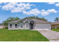 Charming one-story home with a well-manicured lawn and a two car garage at 856 Jarnac Dr, Kissimmee, FL 34759